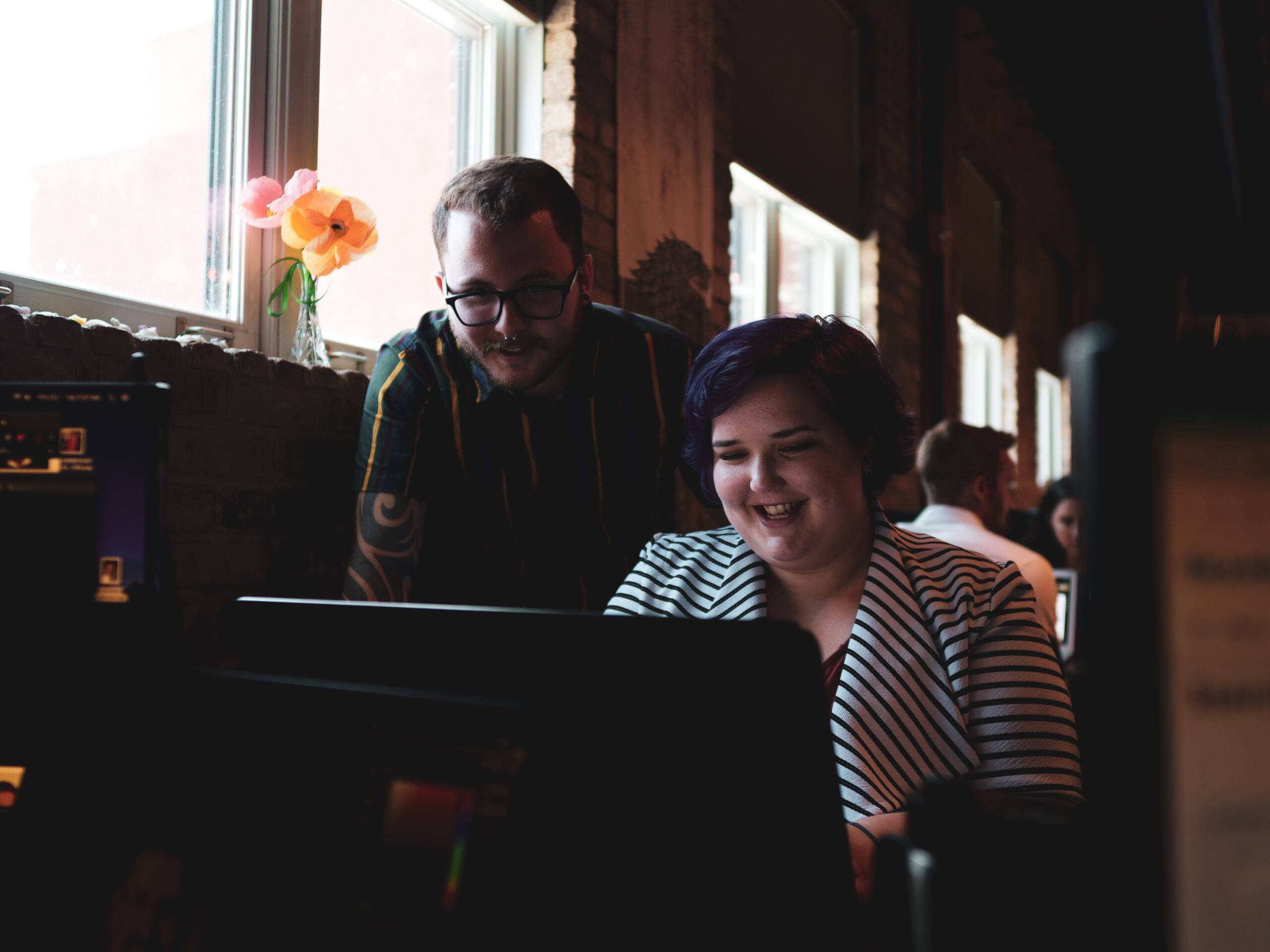 Adapting Social team members working on a laptop