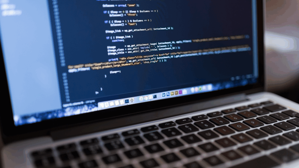 A laptop with a bunch of codes on screen for a web development project.